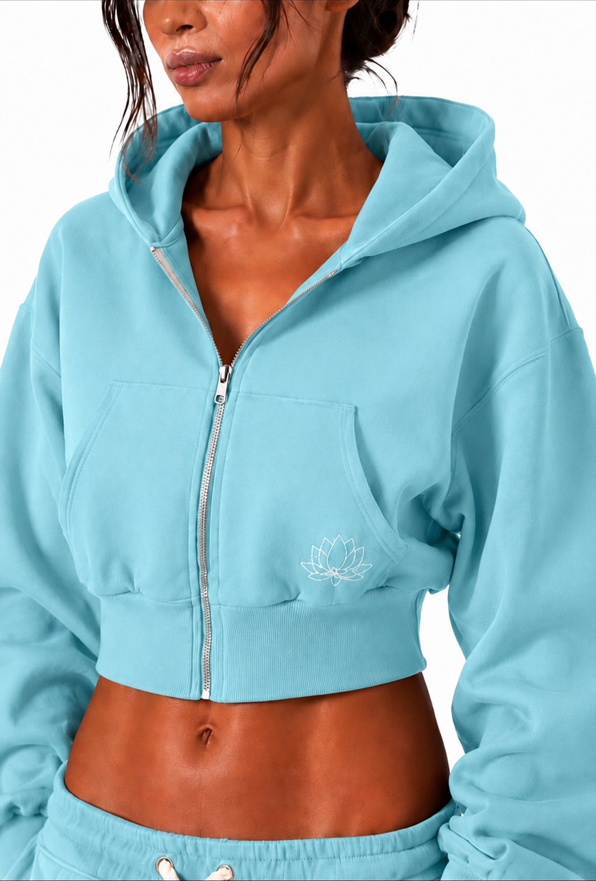 Front view of the Lotus Blue cropped zip-up hoodie with full zip, pockets and signature lotus embroidery.