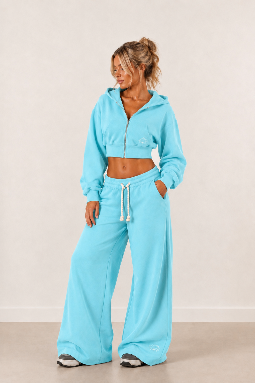 Full-length view of the Lotus Blue cropped zip-up hoodie worn with the matching wide-leg tracksuit bottoms.