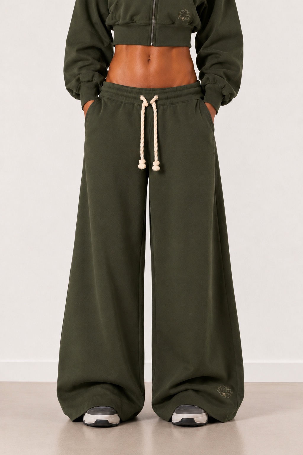 Front view of the Lotus Original Green wide-leg tracksuit bottoms with contrast rope drawcord.